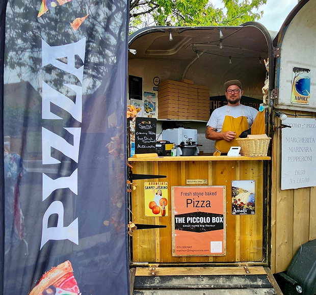 Matt, owner of The Piccolo Box, serving freshly made stone baked pizza from his mobile catering van